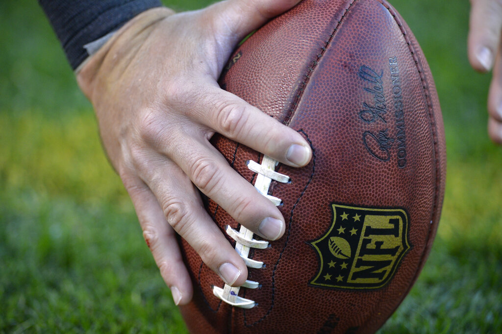 Picture - NFL Football on the ground ready to be snapped.